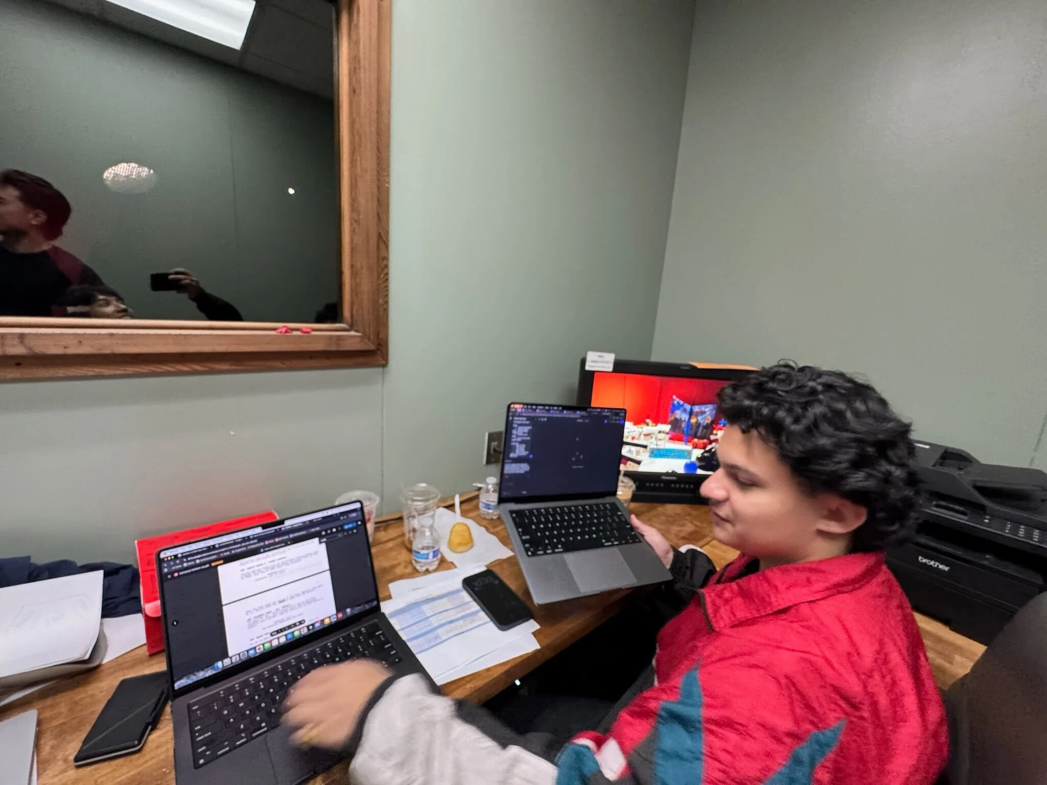 PLEC developer at dual laptop setup during a production shoot